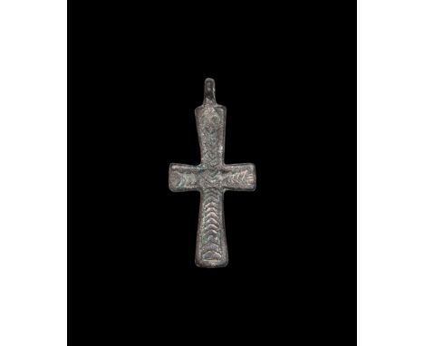 12th-14th century AD. A flat-section bronze cruciform pendant with herringbone hatching to the obverse.   4.81 grams, 52mm (2