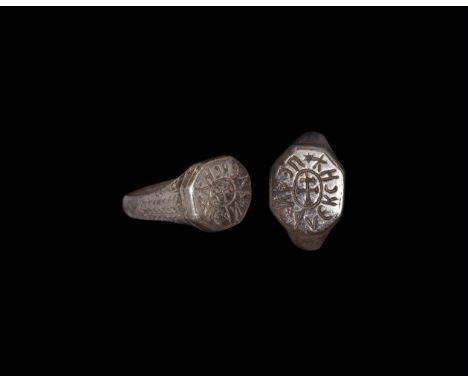6th-7th century AD. A silver finger ring with D-section hoop, faceted shoulders, octagonal plaque with central patriarchal cr