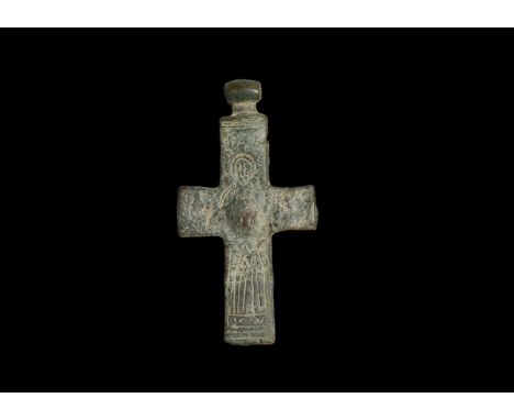 12th-14th century AD. A bronze cross pendant with integral barrel-shaped hoop, central dome, low-relief robed figure with ves