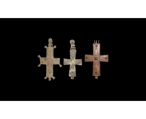 10th-12th century AD. A mixed group of bronze reliquary cross pendants, each with a nimbate saint in orans posture to one fac