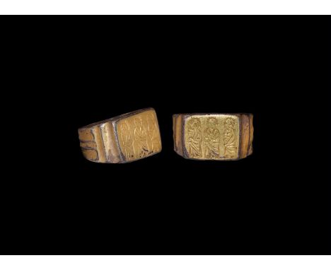 11th-13th century AD. A silver-gilt ring, shank with central rib, shoulder indented; flat rectangular bezel engraved with the