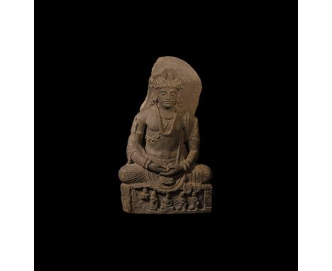 2nd-4th century AD. A large schist statue of Maitreya, seated cross-legged in meditation; hair pulled up into a top-knot with