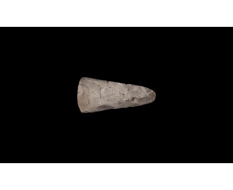 Neolithic Period, 8th-5th millennium BC. A knapped and polished flint axehead with rounded butt, gently curved edge. Cf. Evan