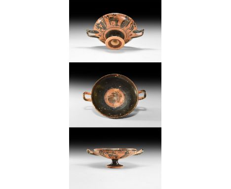 5th-4th century BC. A ceramic black-figure kylix with pedestal base and square handles, shallow bowl; frieze on both sides de