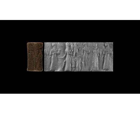 19th-16th century BC. A carved haematite cylinder seal depicting four standing figures, accompanied by a museum quality impre