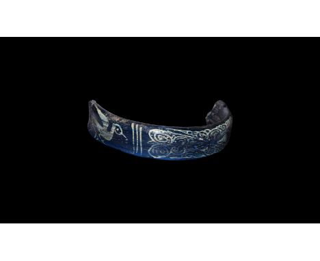6th-8th century AD. A flat-section blue glass bangle fragment with painted design of a foliage plaque and wading bird.   15 g