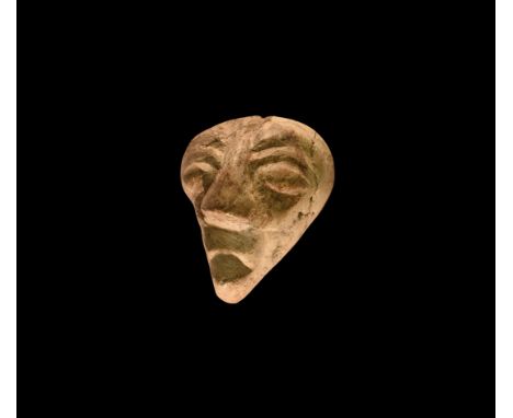 Pliocene Period, 5.2-2.5 million years BP. A mastodon fossil bone, later carving depicting a human face with prominent eyes, 