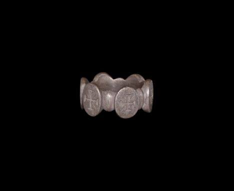 12th-14th century AD. A substantial silver finger ring formed as a D-section hoop with six ellipsoid panels, each with an inc