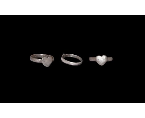 17th century AD. A silver finger ring with flat-section hoop and heart bezel; inscribed to the inner face in seriffed capital