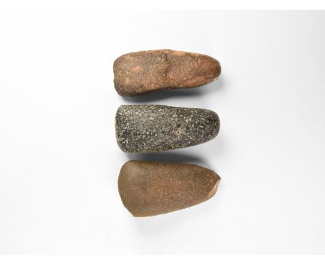 Neolithic, 7th-5th millennium BC. A group of diorite stone pecked and ground Neolithic axeheads with asymmetric convex cuttin