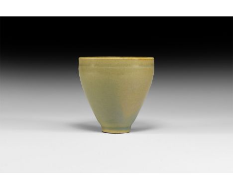 Song Dynasty, 960-1279 AD. A ceramic cup with thin flat rim, lip to the outer edge; body tapering to small foot ring; surface