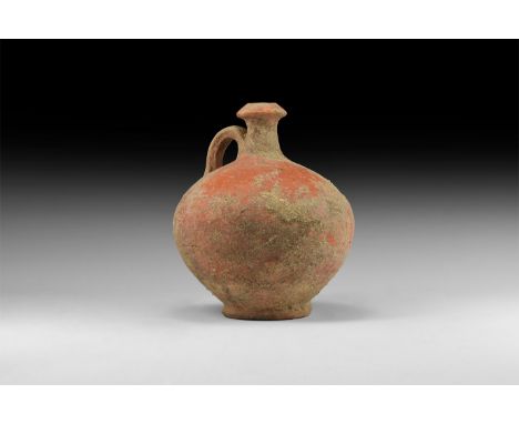 1st century AD. A terracotta flask with bulbous-shaped body, long neck with wide rim and looped handle.   404 grams, 13cm (5"