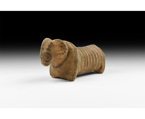 3rd millennium BC. A ceramic figure of a ram with horns curving around head, long body and short legs; painted decoration in 
