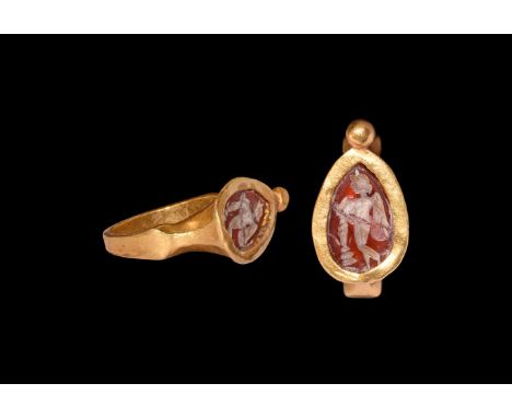 Late 1st millennium BC. A gold finger ring with square-section hoop, scooped shoulders, piriform plaque with granule to the p