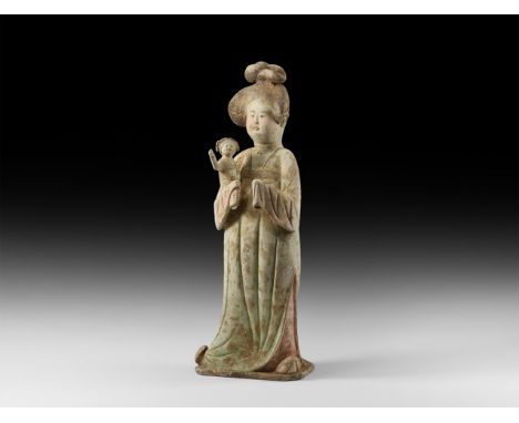 Tang Dynasty, 618-907 AD. A ceramic figure of a female, hair in elaborate style with top-knot in the form of crescents, hair 