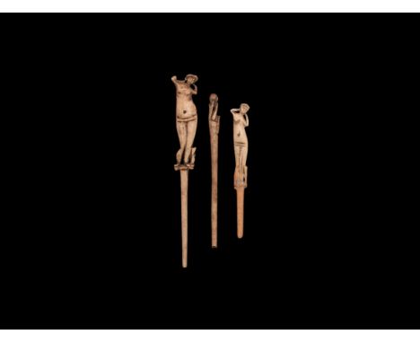 1st-2nd century AD. A mixed group of bone pins comprising: two with finial of Venus standing nude tying a bow into her hair; 