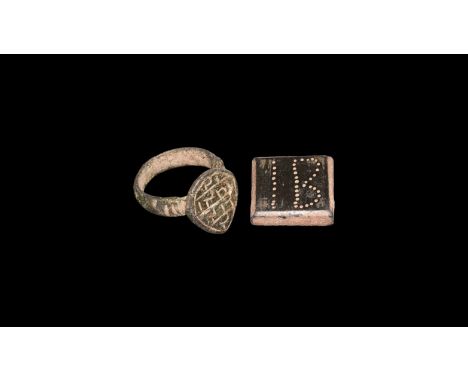 8th-11th century AD. A mixed bronze group comprising: a square weight with pointillé 'IB' legend; a finger ring with teardrop