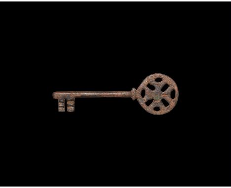 15th century AD. A bronze solid-shaft key with openwork discoid bow, bifid bit with transverse slots, inscribed with low-reli