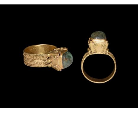 Later 6th-early 7th century AD. A gold finger ring of Type 6c comprising a flat-section hoop with bands of applied filigree r