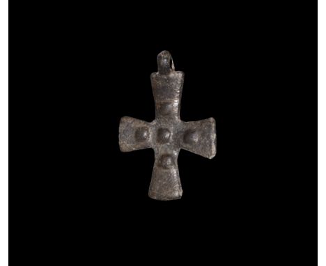 10th-12th century AD. A bronze expanding-arm cross pendant with pierced lug above, five bosses to one face and a single centr
