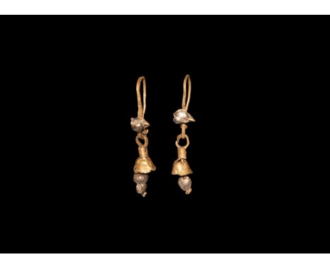 1st century BC-3rd century AD. A matched pair of gold earrings, each flat-section hoop with pearl bead finial, bell-shaped da