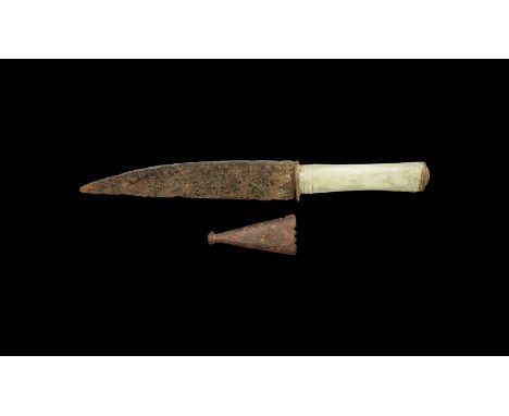 15th century AD. A single-edged iron blade with curved back, narrow bolster, bone grip with incised linear detailing, pommel-