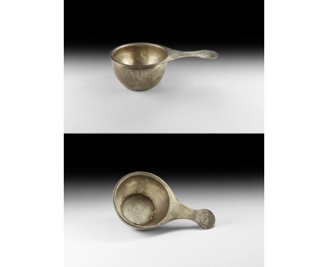 2nd-3rd century AD. A sheet silver bowl or patera with concentric rings to the base, everted rim, waisted handle with discoid