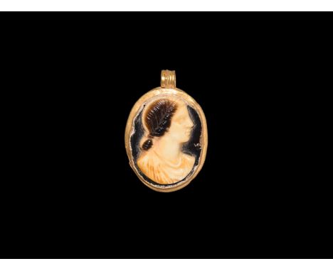 1st-2nd century AD. A cameo portrait bust of a young female with chignon and tunic; set into a later gold pendant comprising 