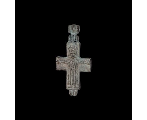 10th-12th century AD. A bronze reliquary cross pendant with hinged barrel loop, to one face a nimbus Corpus Christi with arms