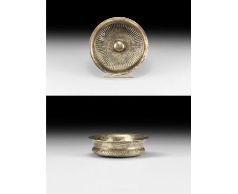 4th-1st century BC. A small silver phiale mesomphalos with flared rim; body with a series of tight repoussé petals radiating 