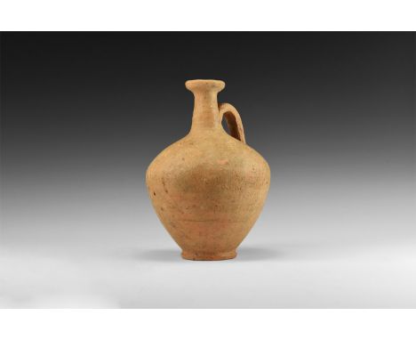1st century AD. A terracotta flask with bulbous-shaped body, long neck with wide rim and looped handle.   293 grams, 14.5cm (