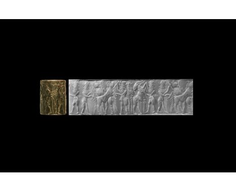 24th-22nd century BC. A deeply engraved ?and well-detailed haematite ?cylinder seal ?with a six-figure contest scene ?of? thr