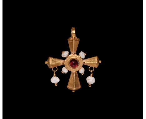 6th-8th century AD. A hollow-formed gold cross pendant with pentagonal-section tapering arms, domed finials with granule, cen