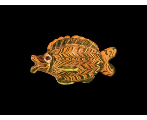 2nd millennium BC or later. A core-formed hollow fish in green glass with orange and white trails, applied blue eyes on white