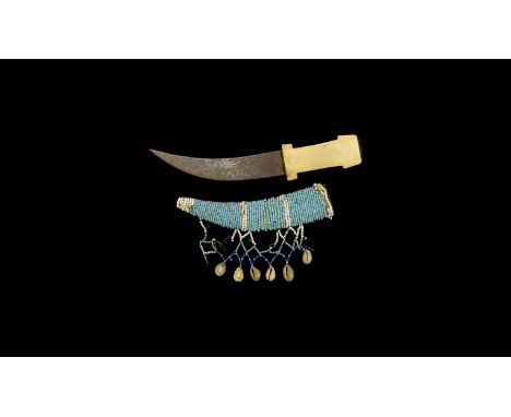 20th century AD. An East African ceremonial dagger comprising a curved steel blade with stamped Arabic lettering, H-shaped bo