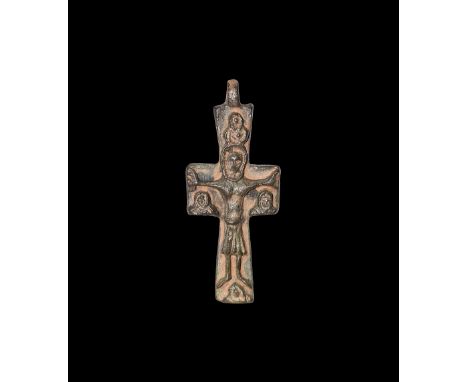 10th-12th century AD. A bronze cruciform pendant with high-relief Corpus Christi flanked by three facing busts.   15 grams, 5