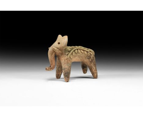19th century AD. A ceramic figure of a standing elephant with curving trunk, short tusks and impressed eyes; applied decorati