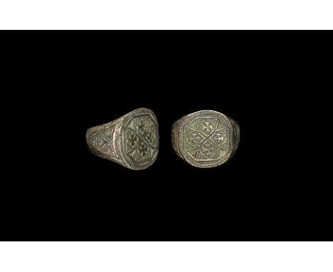 15th century AD. A silver finger ring comprising a flat tapering hoop, with beaded triangle detailing to the spandrels, disco