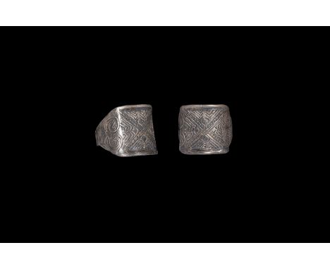 9th-11th century AD. A silver finger ring comprising a square plaque and integral hoop with geometric pointillé detailing. Cf