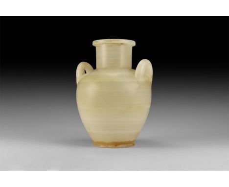 Ptolemaic to Roman Period, 332 BC-440 AD. An alabaster vessel with flat rim, short neck and sloping shoulders; to the shoulde