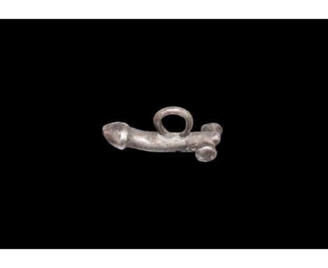 1st-2nd century AD. A silver phallic pendant with suspension ring to the back.   3.95 grams, 24mm (1"). From the collection o