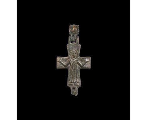 10th-12th century AD. A bronze reliquary cross pendant with barrel loop, high-relief Corpus Christi and cross to one face, Ma