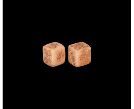 1st-2nd century AD. A matched pair of bone dice with ring-and-dot markings distributed 1:6, 3:5, 4:2. See Allason-Jones, L. &