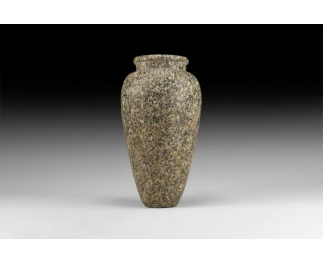 1st Dynasty, 3218-3035 BC. A speckled granite piriform vessel with flat rim, short neck; rounded shoulder with tapering body,