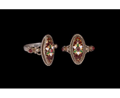 18th century AD. A silver finger ring with gusset to the hoop, cell to each shoulder with inset glass cabochon, scaphoid beze