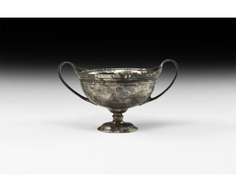 4th-1st century BC. A silver kantharos or wine cup with deep spherical body supported on a round stand; incised with a band a