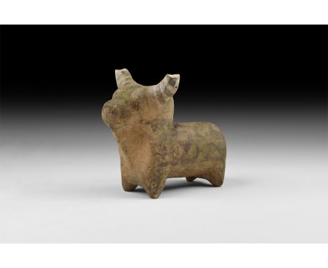 3rd millennium BC. A ceramic figure of a bull with curving horns, dewlap and hump to the back of the neck; cylindrical body w
