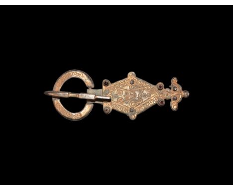5th century AD. A silver-gilt belt buckle comprising: an annular loop with running scroll detailing; square-section tongue wi