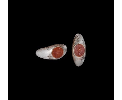 3rd century AD. A silver finger ring with keeled profile, inset discoid carnelian cloison with intaglio with goddess Fortuna 