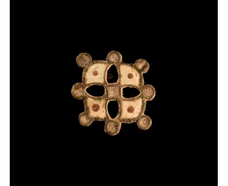 2nd century AD. A silver plate brooch formed as a cross patté with pellets to the outer edge, white enamelled lobes and centr